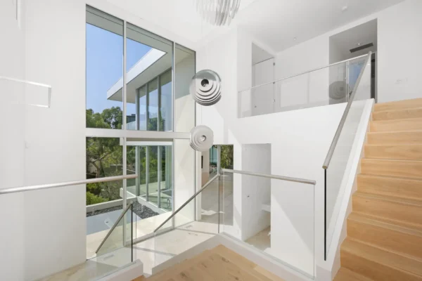 Residential interior with windows and a ceiling fan in the corner A residential interior with windows and a ceiling fan in the corner
